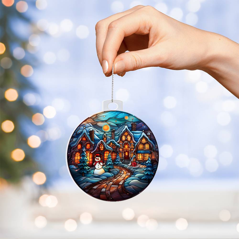 Hand holding frosty town acrylic ornament with snowy town design, perfect Christmas gift.